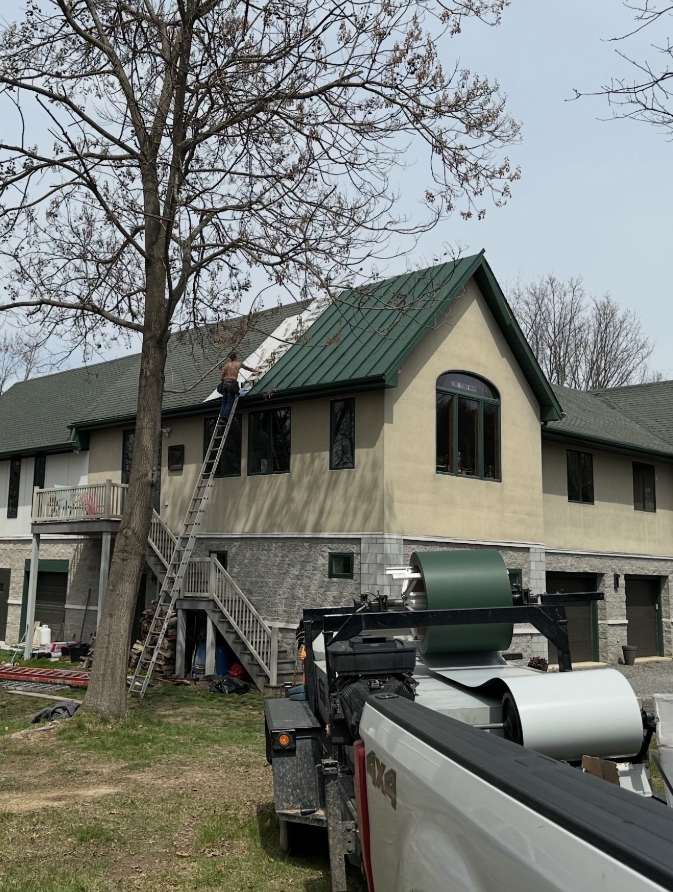 green metal roof project over shingles by Eclipse Construction