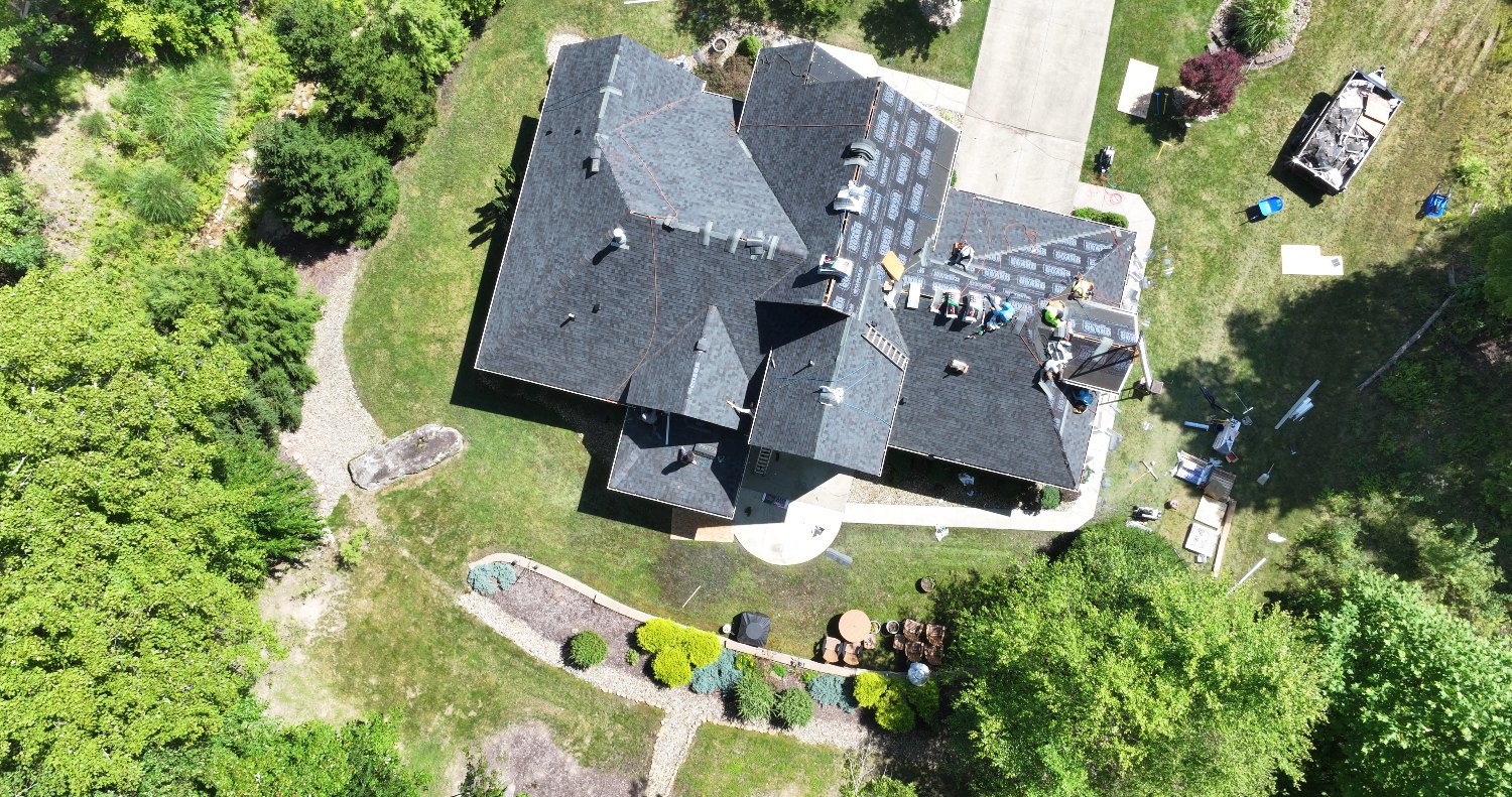 Roofers installing new Class 3 impact-resistant shingles on a Cheat Lake WV home
