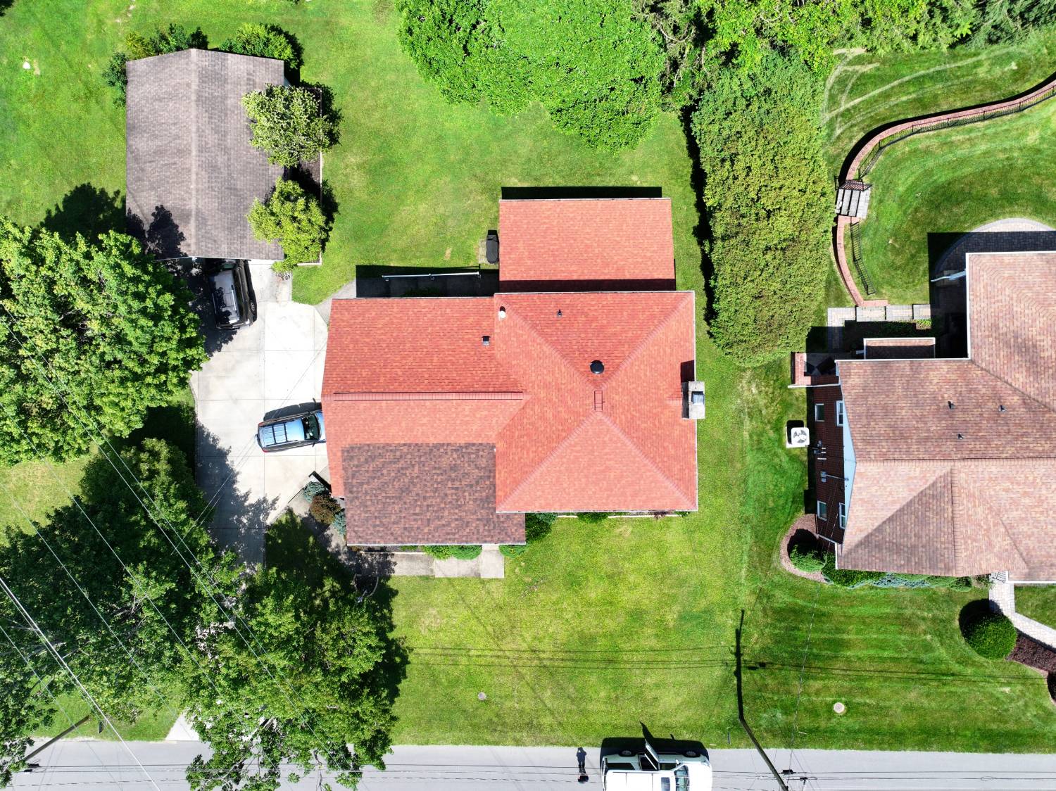 Aerial view of the same Morgantown WV home after a full roof replacement with new red architectural shingles