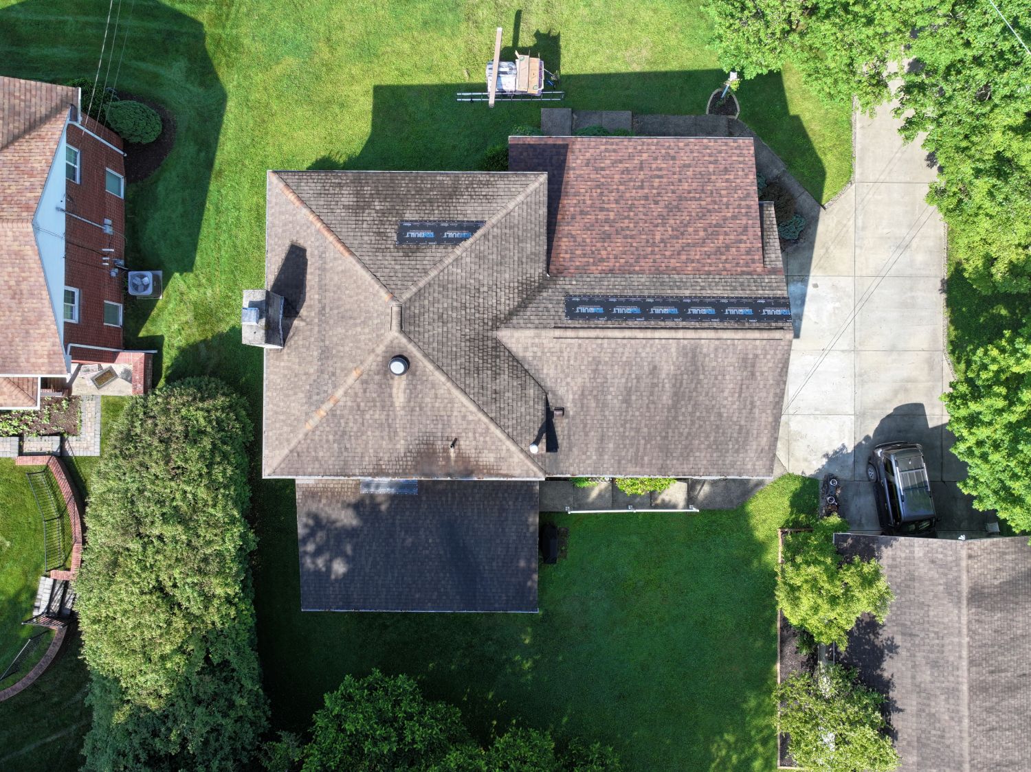 Aerial view of a Morgantown WV home before roof replacement, with worn and stained brown shingles